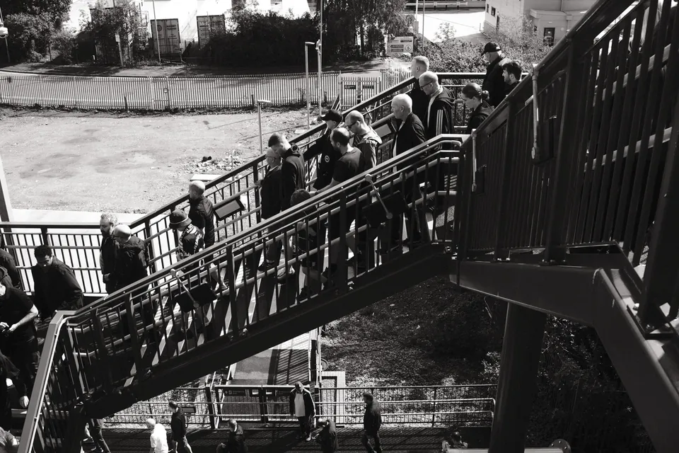 Supporters descending the metal stairs of Sandhills’ new matchday footbridge, on the journey to Bramley Moore (Hill Dickinson Stadium).