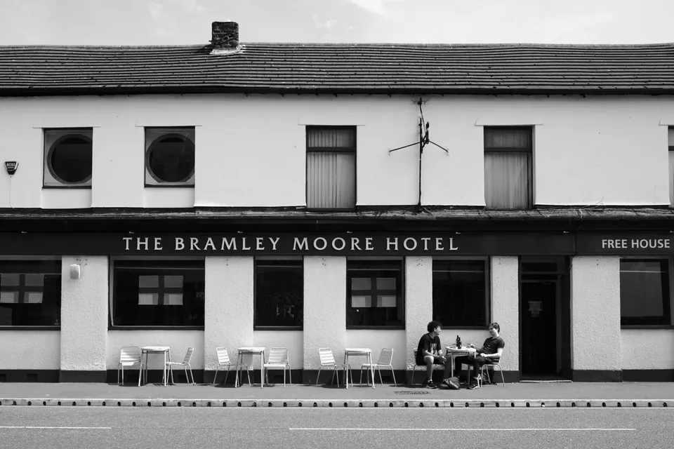 Photograph: The front of the Bramley Moore Hotel with people seated outside.